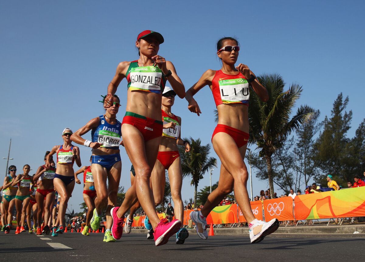 Maria Guadalupe Gonzalez of Mexico and Hong Liu of China compete in the women’s 20-kilometer walk final.
