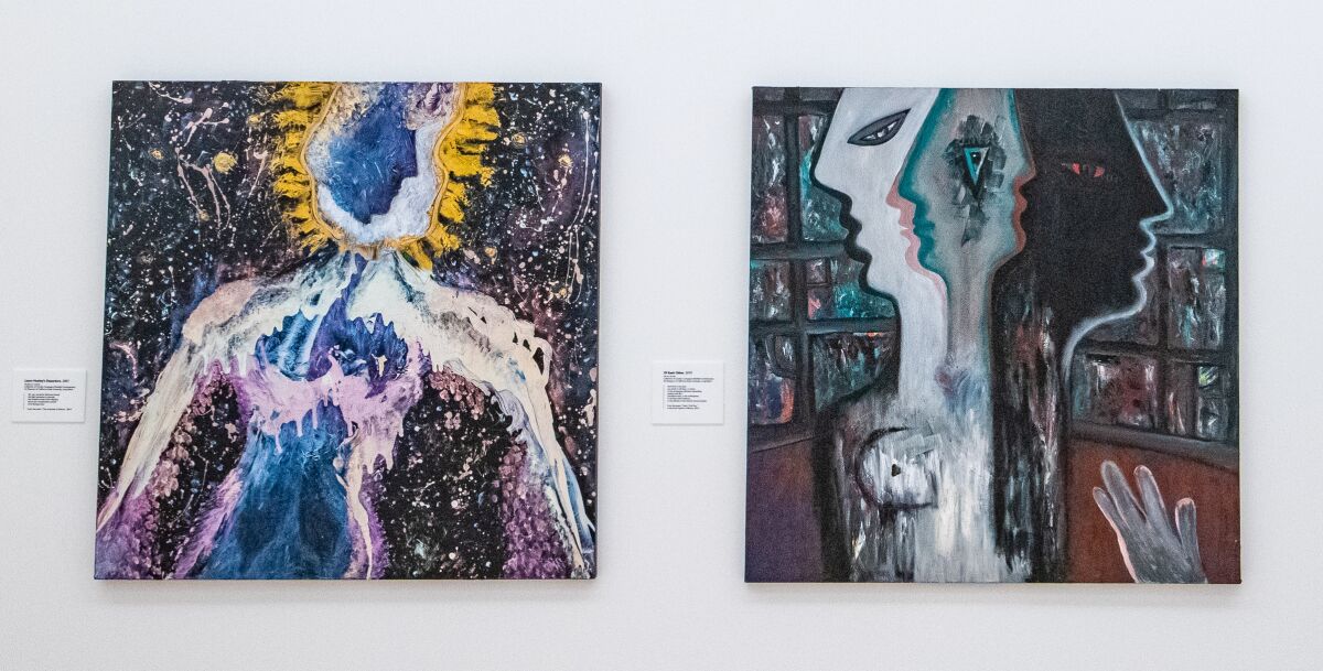 Two paintings hanging on a gallery wall