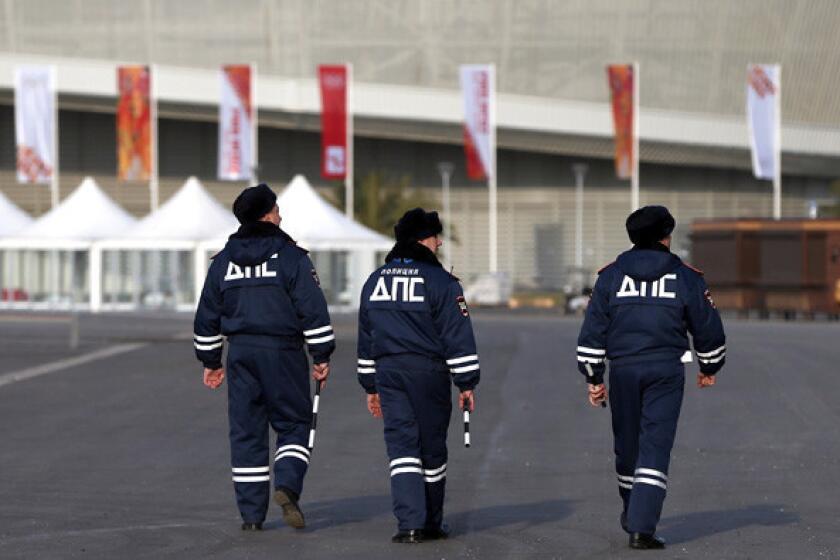 Security personnel walk in the Olympic Park in Adler, Russia, one of the cities near Sochi that is helping to play host to the 2014 Winter Olympics.