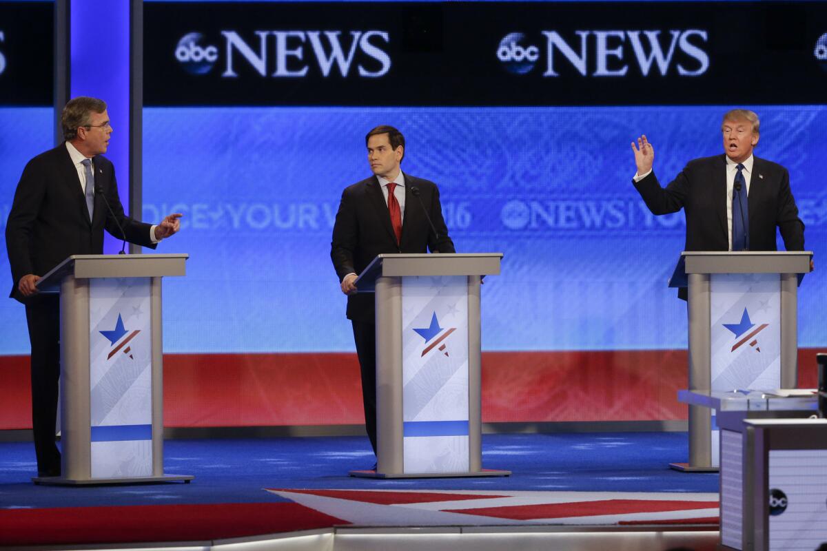 Marco Rubio looks on as Jeb Bush, left, and Donald Trump, right, spar at the debate.