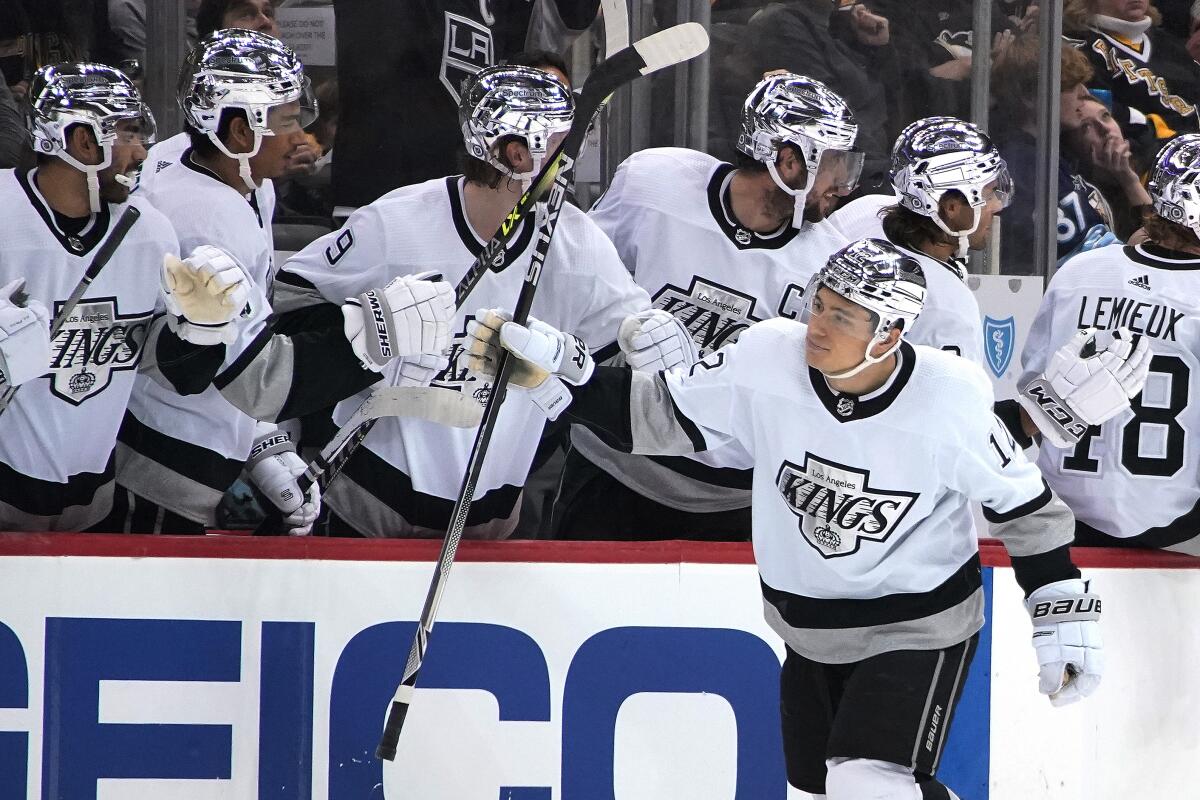 Kings forward Trevor Moore celebrates with his teammates after scoring a goal.
