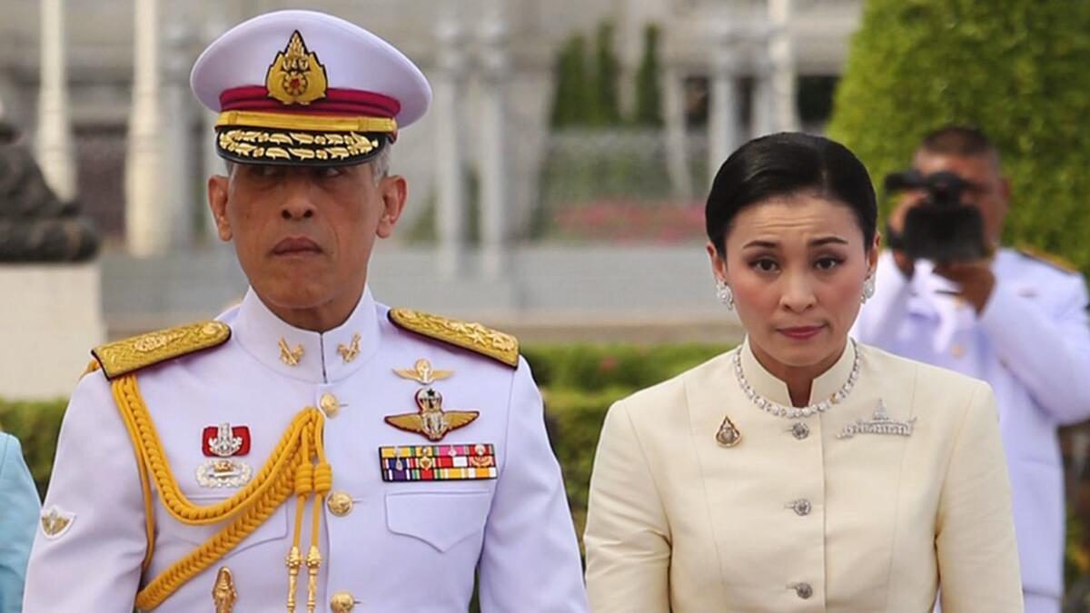 Thai King Maha Vajiralongkorn is accompanied by Queen Suthida ahead of a coronation ceremony at the Royal Plaza in Bangkok, Thailand, on May 2.