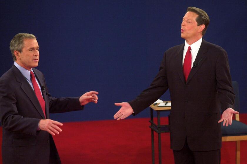 ST. LOUIS, UNITED STATES: Republican presidential nominee George W. Bush (L) and Democratic presidential nominee Al Gore talk during their third debate at Washington University in St. Louis, MO, 17 October, 2000. AFP PHOTO/Tannen MAURY (Photo credit should read TANNEN MAURY/AFP via Getty Images)