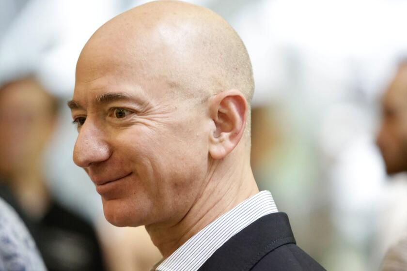(FILES) In this file photo taken on January 29, 2018 Chief Executive Officer of Amazon, Jeff Bezos, tours the facility at the grand opening of the Amazon Spheres, in Seattle, Washington. - As Amazon became the second US firm to hit a trillion-dollar value on the stock market, founder Jeff Bezos regained the crown as the richest person on the planet. Amazon's share price has climbed during the year, lifting the personal wealth of the company's 54-year-old founder with it. Forbes estimated his net worth about $166 billion. (Photo by JASON REDMOND / AFP)JASON REDMOND/AFP/Getty Images ** OUTS - ELSENT, FPG, CM - OUTS * NM, PH, VA if sourced by CT, LA or MoD **