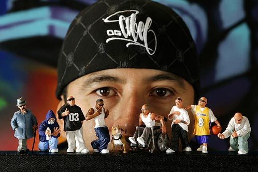 Abel "OG Abel" Izaguirre, 37, with some of the 2-inch Locsters series figurines he developed that show a graphic and cynical depiction of urban Los Angeles.