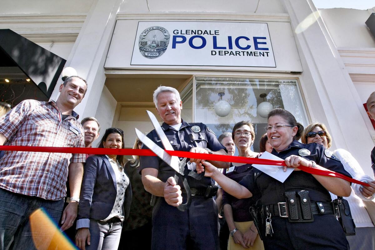 Glendale Police Chief Ron De Pompa, center, and other dignitaries participate in the ribbon cutting ceremony at the grand re-opening of the Glendale Police Montrose substation on Ocean View Boulevard in Montrose on Tuesday, Oct. 15, 2013. About 100 people came to the celebration.