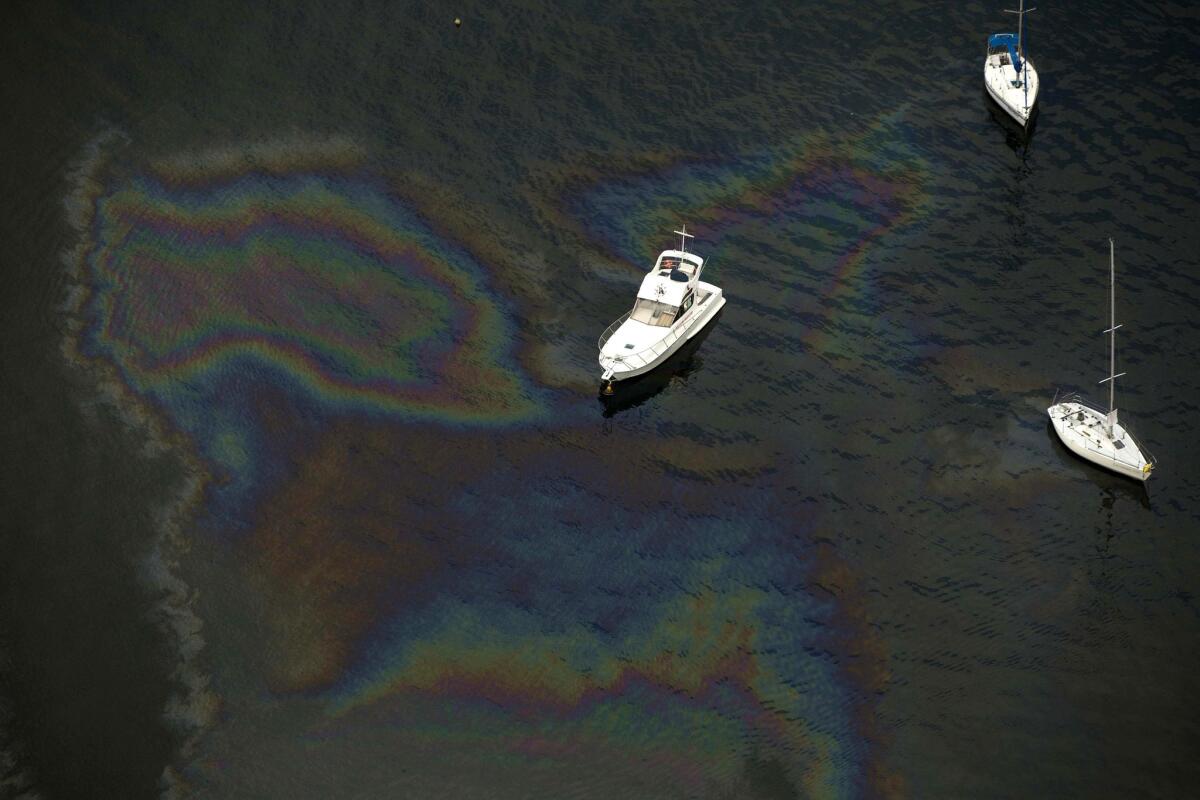 Boats amid an oil slick in Guanabara Bay where the sailing competitions at the 2016 Rio Olympic Games will be held on May 21.