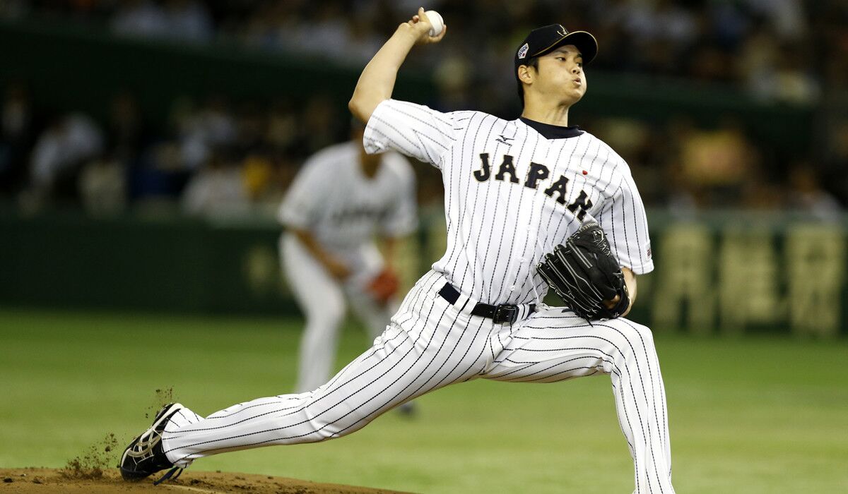 Shohei Ohtani pitches against South Korea during the first inning of Japan's semifinal game at the Premier 12 world baseball tournament at the Tokyo Dome.