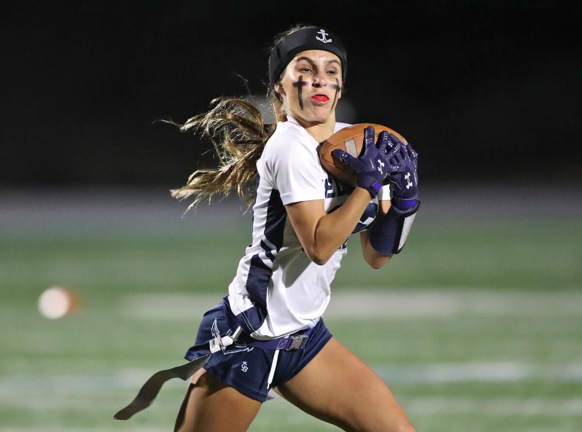 Newport Harbor's Skylie Cid (33) makes a catch during girls' flag football action against Corona del Mar on Monday.