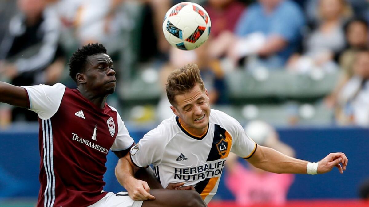 Galaxy forward Robbie Rogers, right, challenging Colorado Rapids forward Dominique Badji for the ball in MLS playoff game in 2016, is retiring.