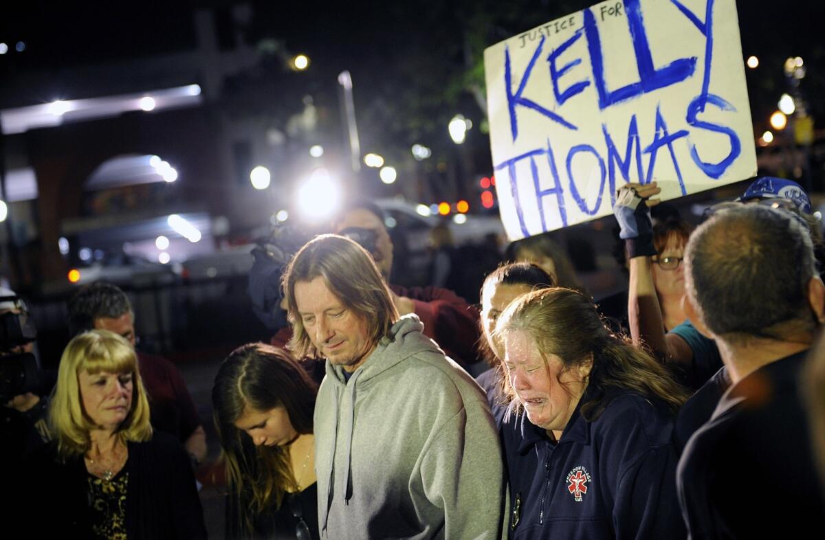 Friends, family and supporters stand at "Kelly's Corner" on Monday night after two former Fullerton police officers were found not guilty of the murder of Kelly Thomas.