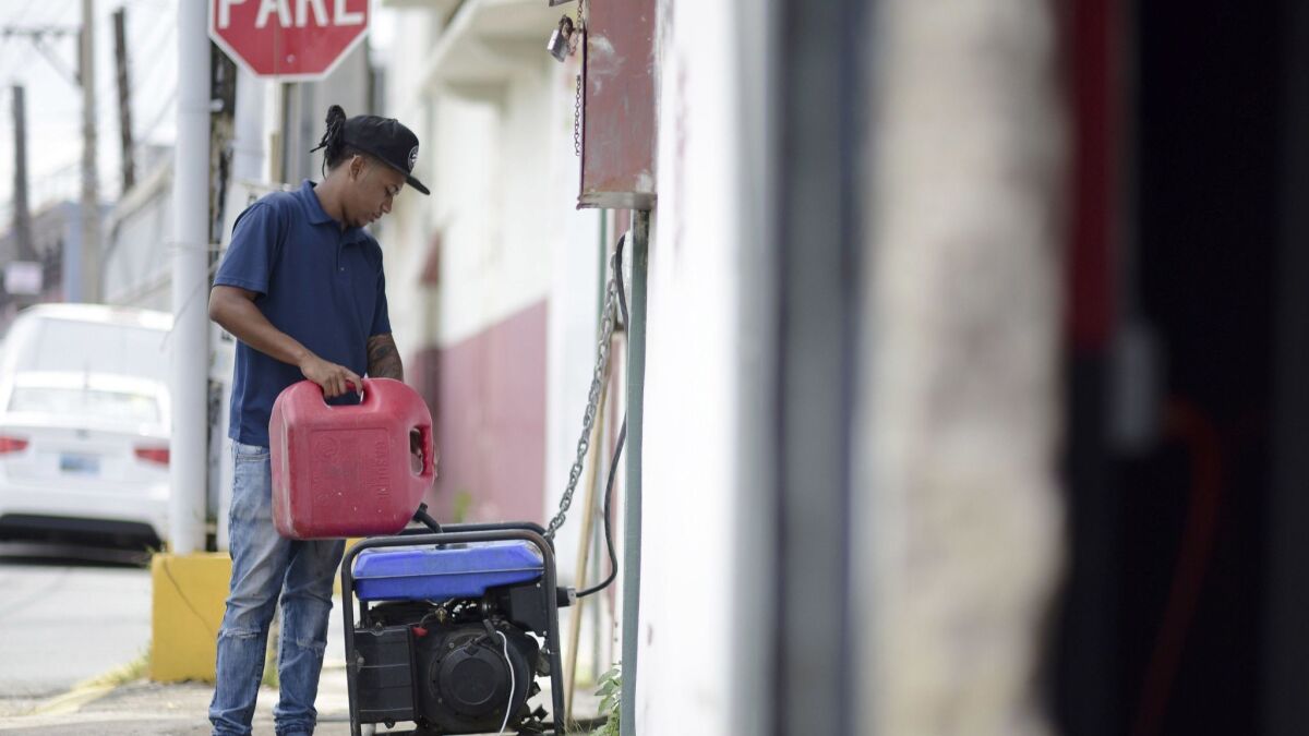 Juan Castro fills a generator with gasoline in San Juan, Puerto Rico.