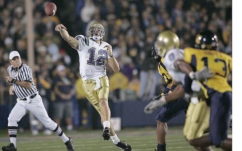 UCLA Bruins quarterback Pat Cowan rolls out to complete a second quarter pass to receiver Junior Taylor at Memorial Stadium in Berkeley, California, Saturday.