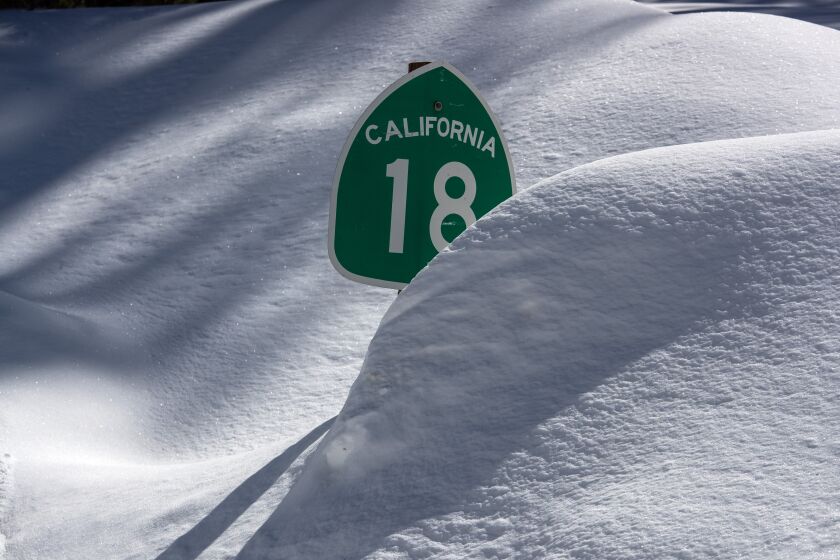 BIG BEAR LAKE, CA - MARCH 03: Many street signs are nearly covered as the Big Bear Valley digs out following successive storms which blanketed San Bernardino Mountain communities on Friday, March 3, 2023 in Big Bear Lake, CA. (Brian van der Brug / Los Angeles Times)