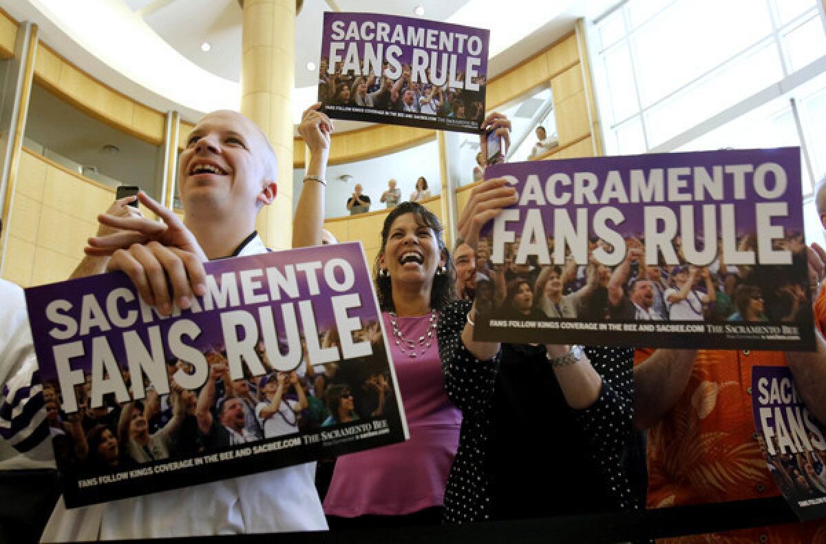 Sacramento Kings fans at City Hall celebrate the announcement that the team has been sold to investors who won't move the club.