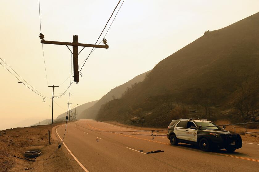 Only the top few feet of a utility pole survived the Woolsey fire as it roared over Kanan Road in Malibu.