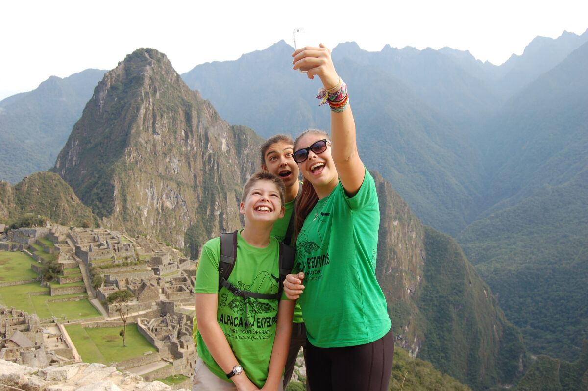 The Wheelan family poses for a selfie at a deserted Machu Picchu, in Peru.