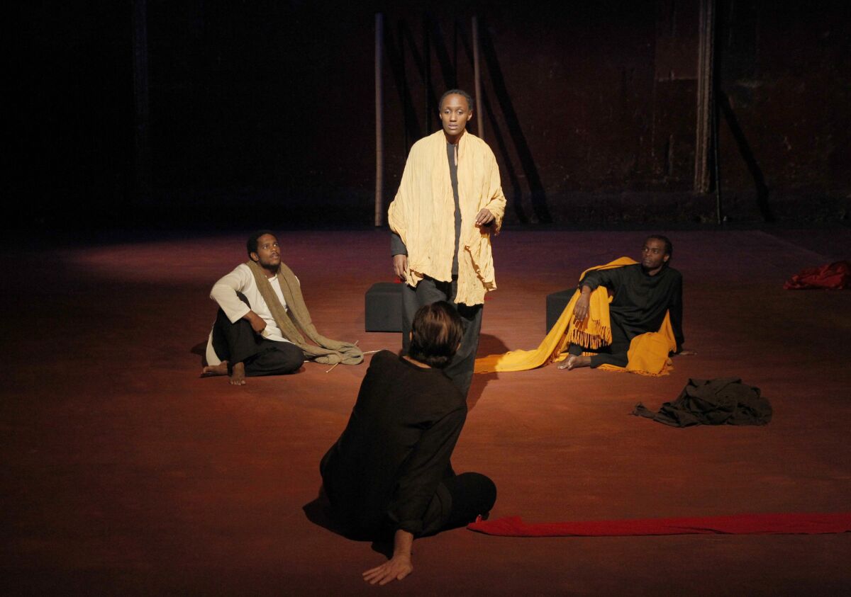 Carole Karemera surrounded by, from left, Jared McNeill, Sean O'Callaghan and Ery Nzaramba in Peter Brook's "Battlefield." (Pascal Victor / ArtComArt)