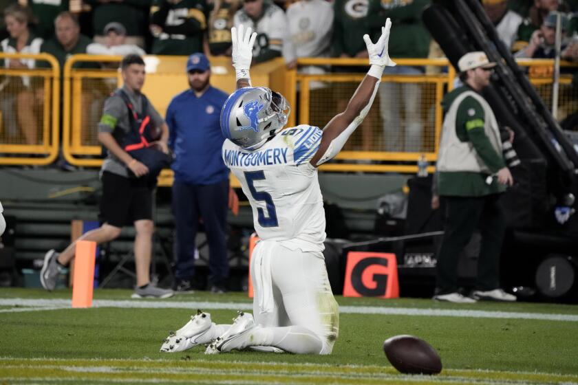 Detroit Lions running back David Montgomery (5) celebrates after a 2-yard touchdown run during the first half of an NFL football game against the Green Bay Packers, Thursday, Sept. 28, 2023, in Green Bay, Wis. (AP Photo/Morry Gash)