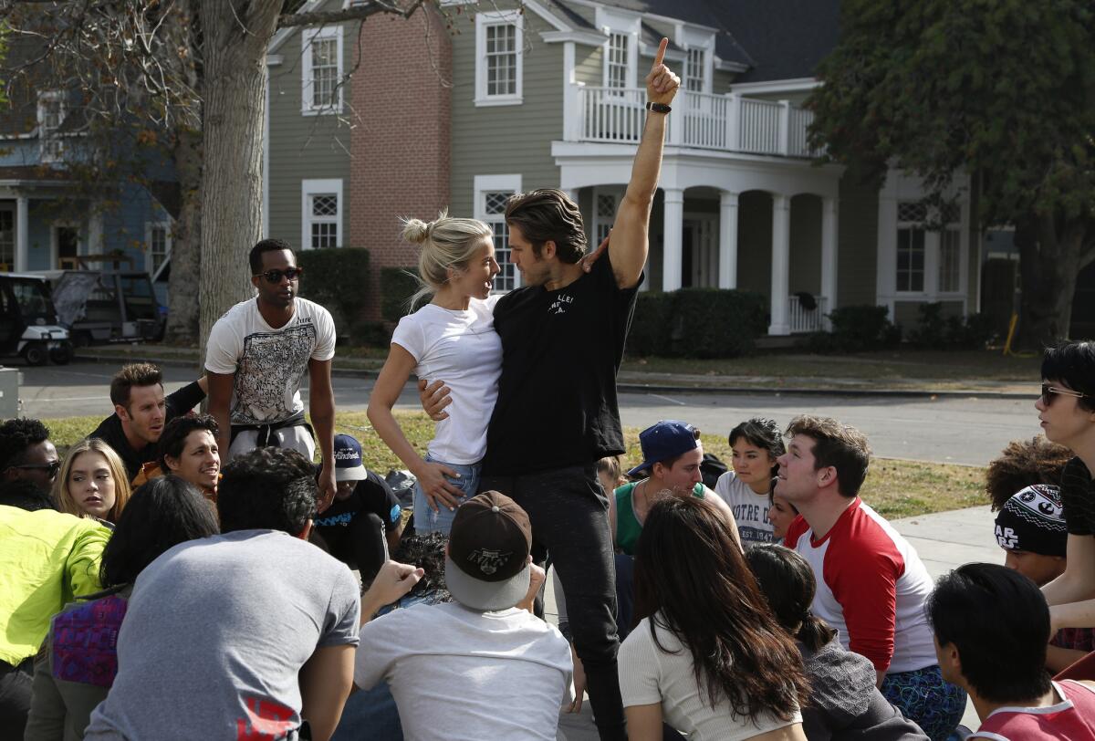 Julianne Hough, left, who plays Sandy, and Aaron Tveit, who plays Danny, and the rest of the cast and ensemble, rehearse a scene for Fox's upcoming "Grease: Live" musical production.