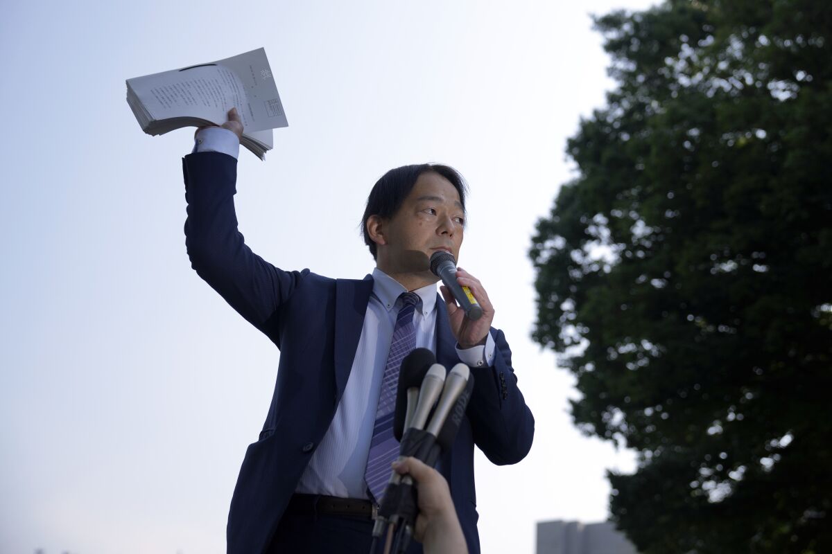 Izutaro Managi, a lawyer for the plaintiffs, speaks to plaintiffs and their supporters after hearing the decision of the Tokyo Supreme Court, Friday, June 17, 2022, in Tokyo. Japan’s top court on Friday ruled that the government was not liable for the 2011 Fukushima nuclear crisis, dismissing thousands of evacuees's demands that the state, not just the utility, should pay compensation for the damages inflicted to their lives. (AP Photo/Eugene Hoshiko)