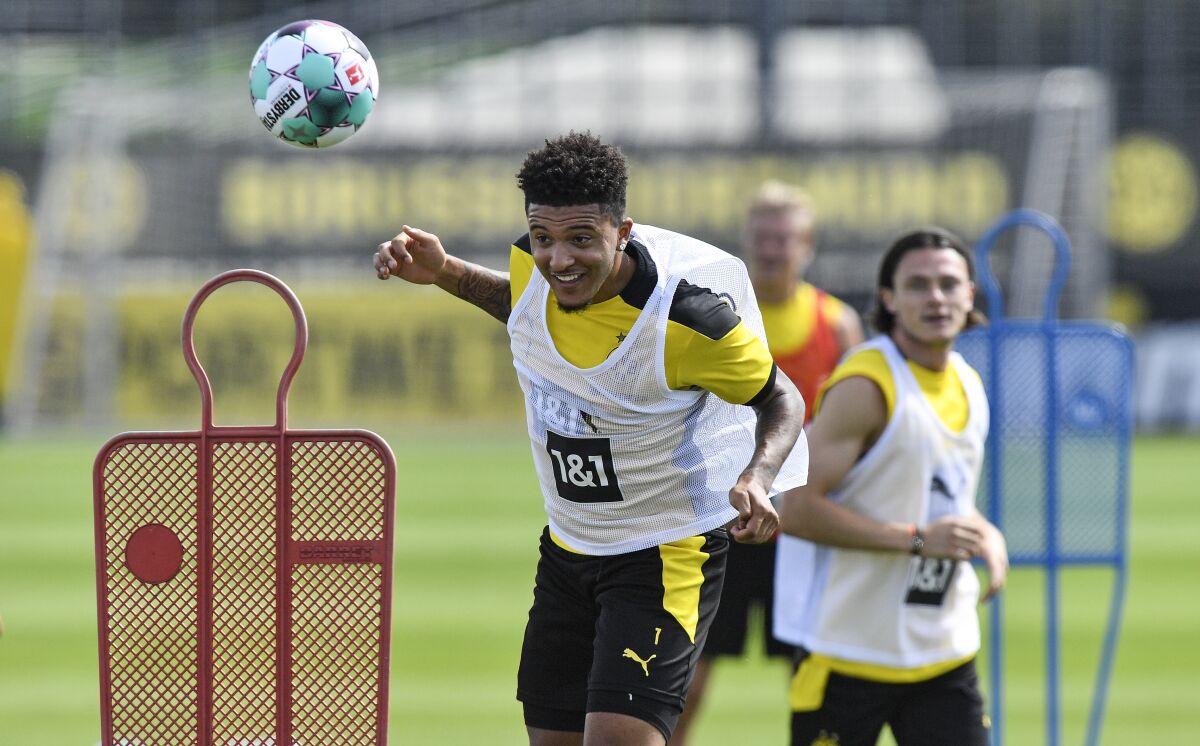 Dortmund's Jadon Sancho heads the ball during the first training session of German Bundesliga club Borussia Dortmund at the training grounds in Dortmund, Germany, Monday, Aug. 3, 2020. (AP Photo/Martin Meissner)
