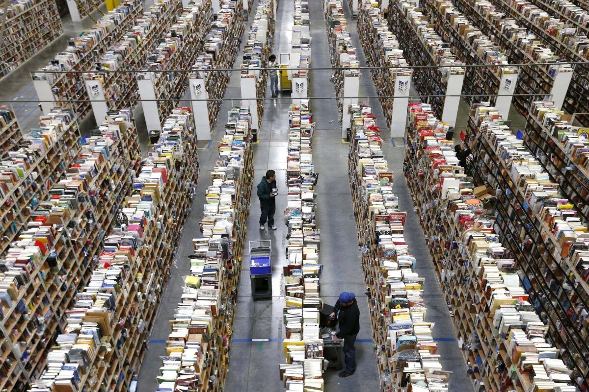 Employees stock shelves at an Amazon.com warehouse on Cyber Monday.