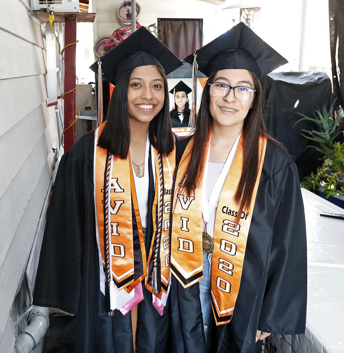 Alexandra Lopez, left, and Karen Arzola celebrated with family and friends at a virtual graduation ceremony for Los Amigos.