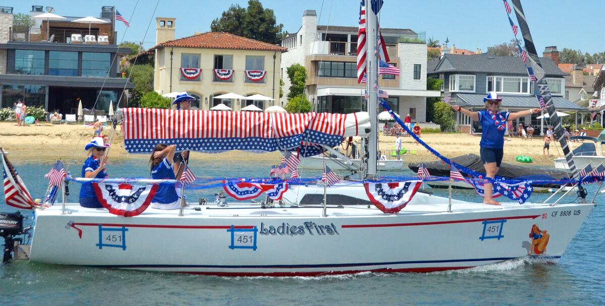 An all-female crew navigates the vessel "Ladies First" around Newport Harbor during the Old Glory Fourth of July boat parade.