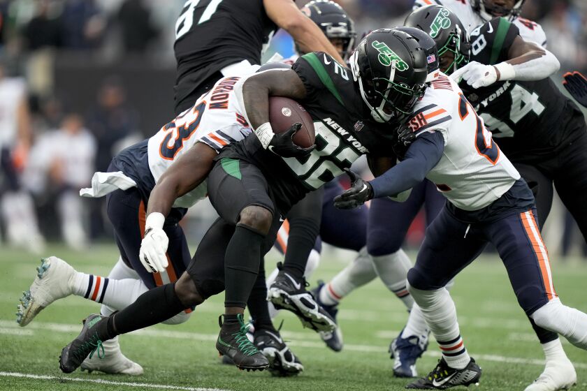 New York Jets running back Michael Carter (32) carries the ball against the Chicago Bears during the first quarter of an NFL football game, Sunday, Nov. 27, 2022, in East Rutherford, N.J. (AP Photo/John Minchillo)