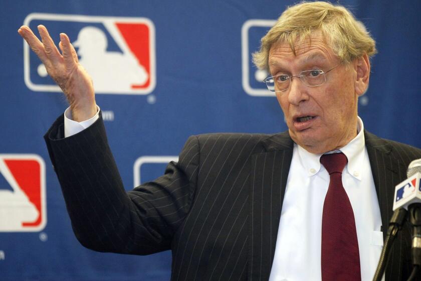 Baseball Commissioner Bud Selig talks with reporters after a meeting with team owners in Chicago.