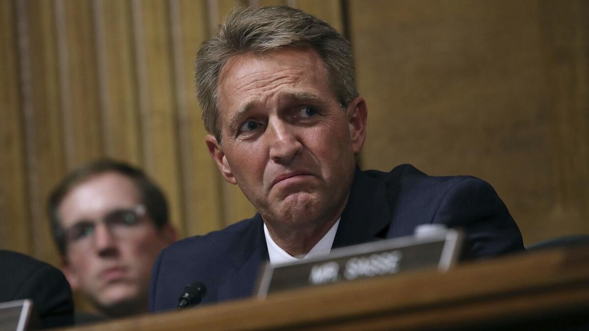 Sen. Jeff Flake (R-Ariz.), the Senate Judiciary Committee's only undecided member on the nomination of Judge Brett Kavanaugh to the Supreme Court, listens to testimony during Thursday's hearing.