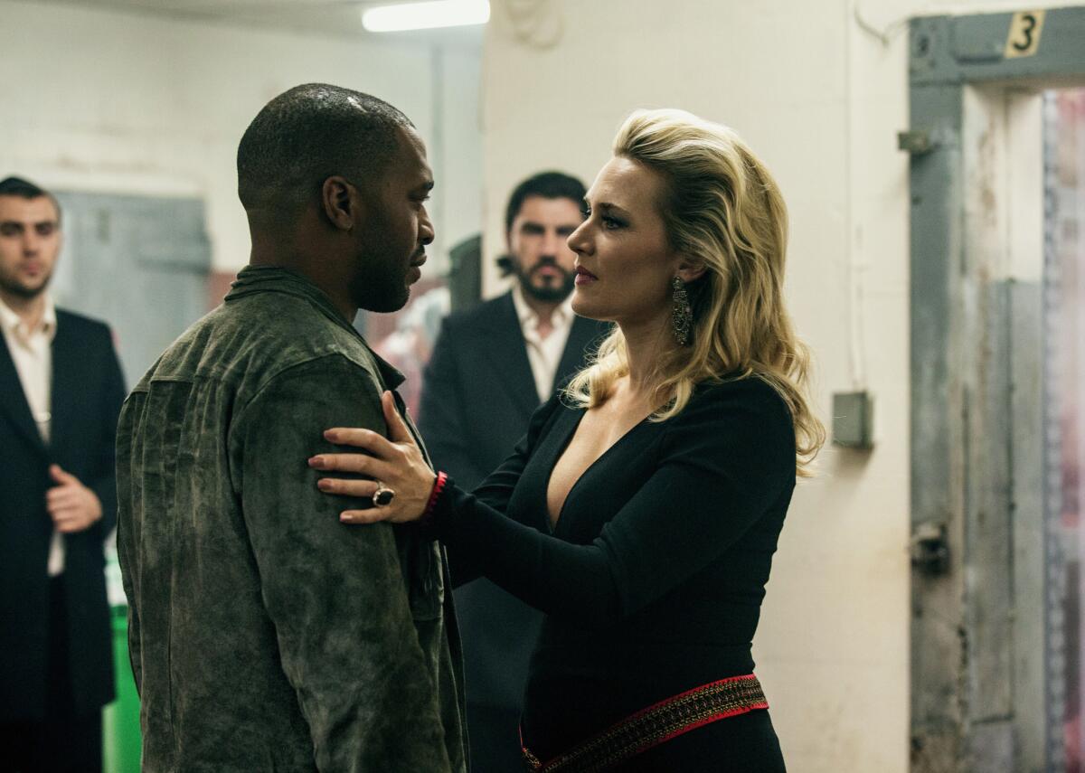 Chiwetel Ejiofor, left, and Kate Winslet in a scene from "Triple 9."