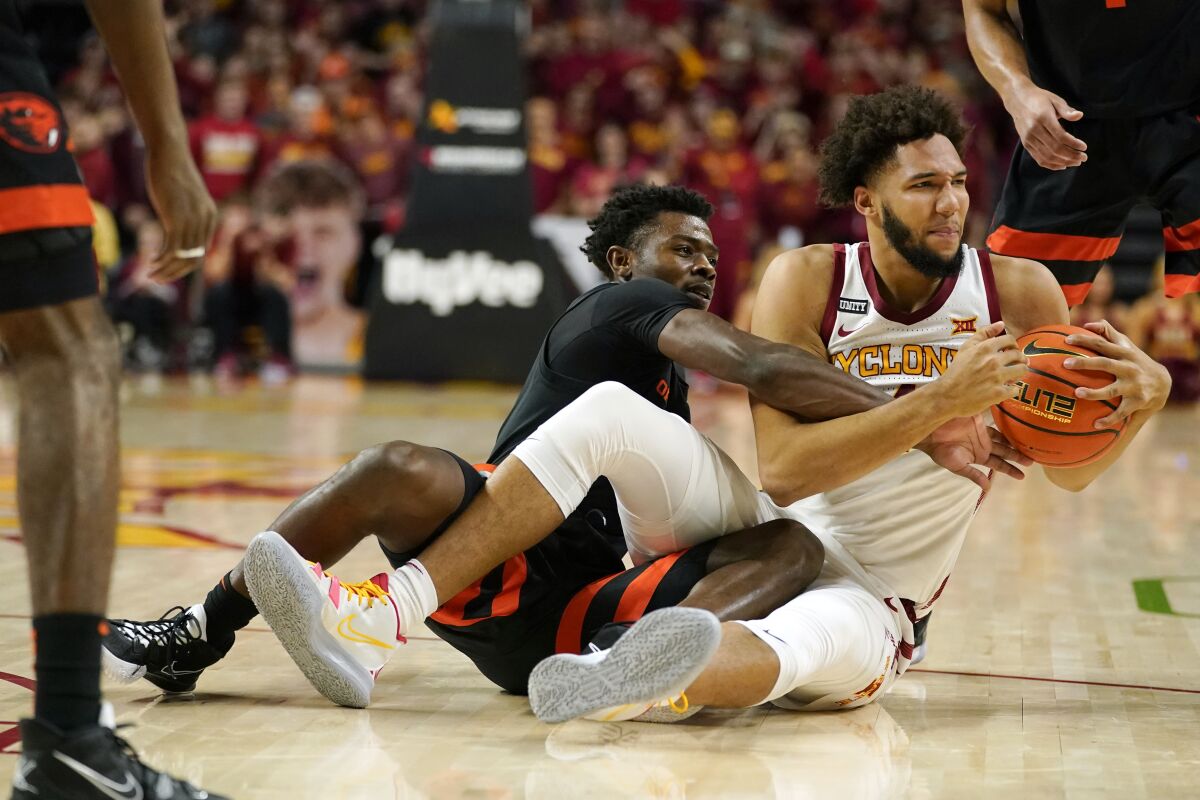 Iowa State forward George Conditt IV is fouled by Oregon State guard Dashawn Davis, left, during the first half of an NCAA college basketball game, Friday, Nov. 12, 2021, in Ames, Iowa. (AP Photo/Charlie Neibergall)
