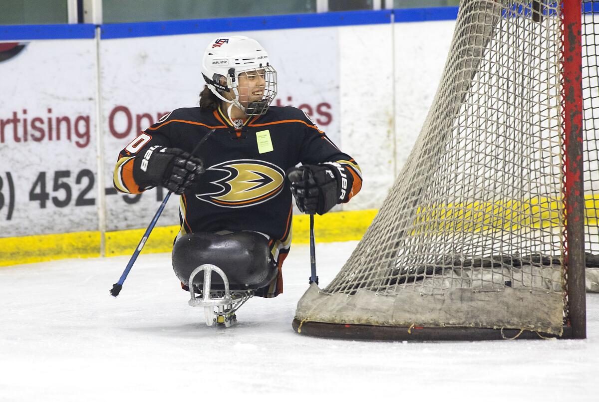 Lera Doederlein smiles while taking part in San Diego Ducks sled hockey practice.