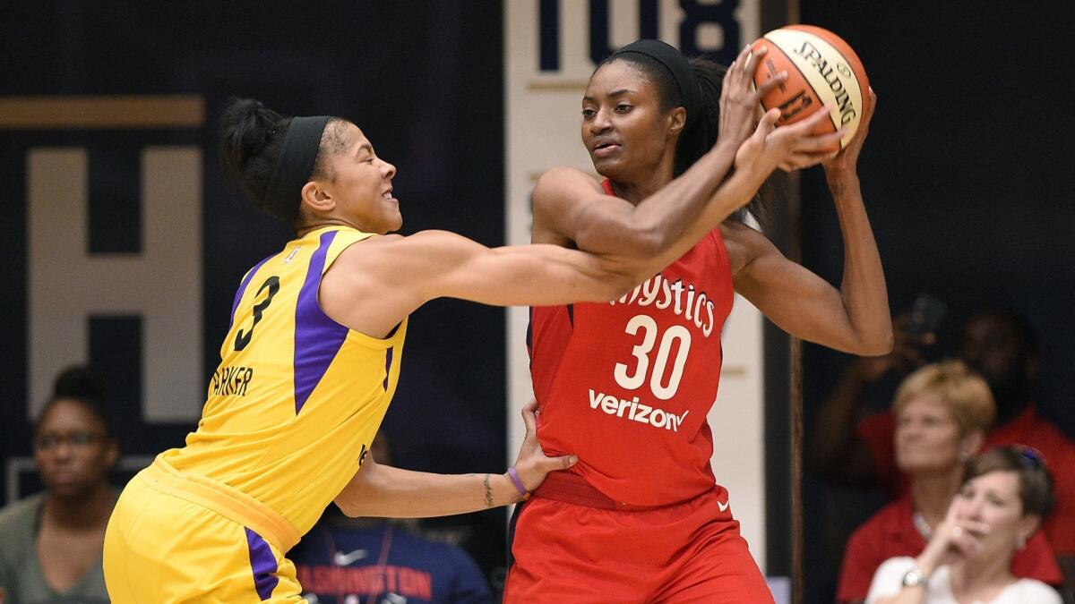 Washington Mystics forward LaToya Sanders, right, tries to keep the ball away from Sparks forward Candace Parker during a game in August.