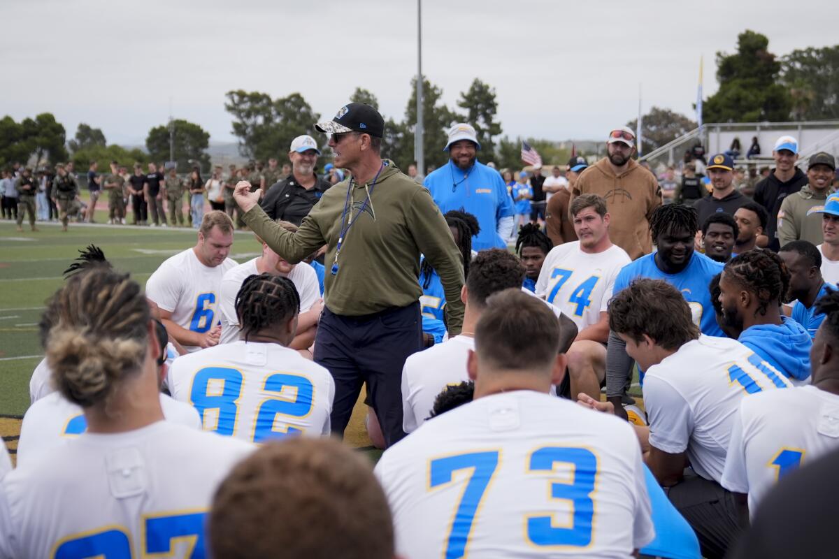 Coach Jim Harbaugh addresses his Chargers at the Marine Corps Base Camp Pendleton.