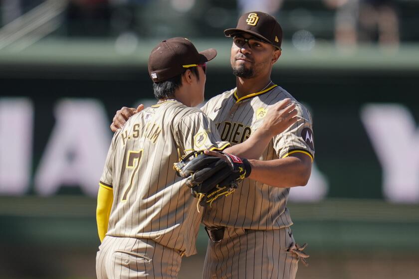 San Diego Padres' Ha-Seong Kim, left, and Xander Bogaerts celebrate their team's 3-0 win over the Chicago Cubs followiing a baseball game Wednesday, May 8, 2024, in Chicago. (AP Photo/Erin Hooley)