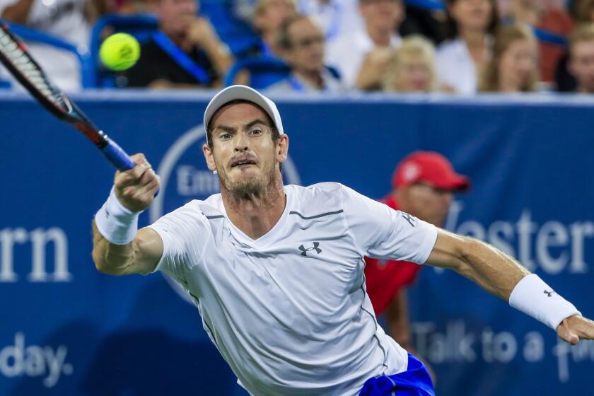Andy Murray hits a return shot against Juan Monaco during a second round match at the Western & Southern Open tennis championships at the Linder Family Tennis Center in Mason, Ohio.