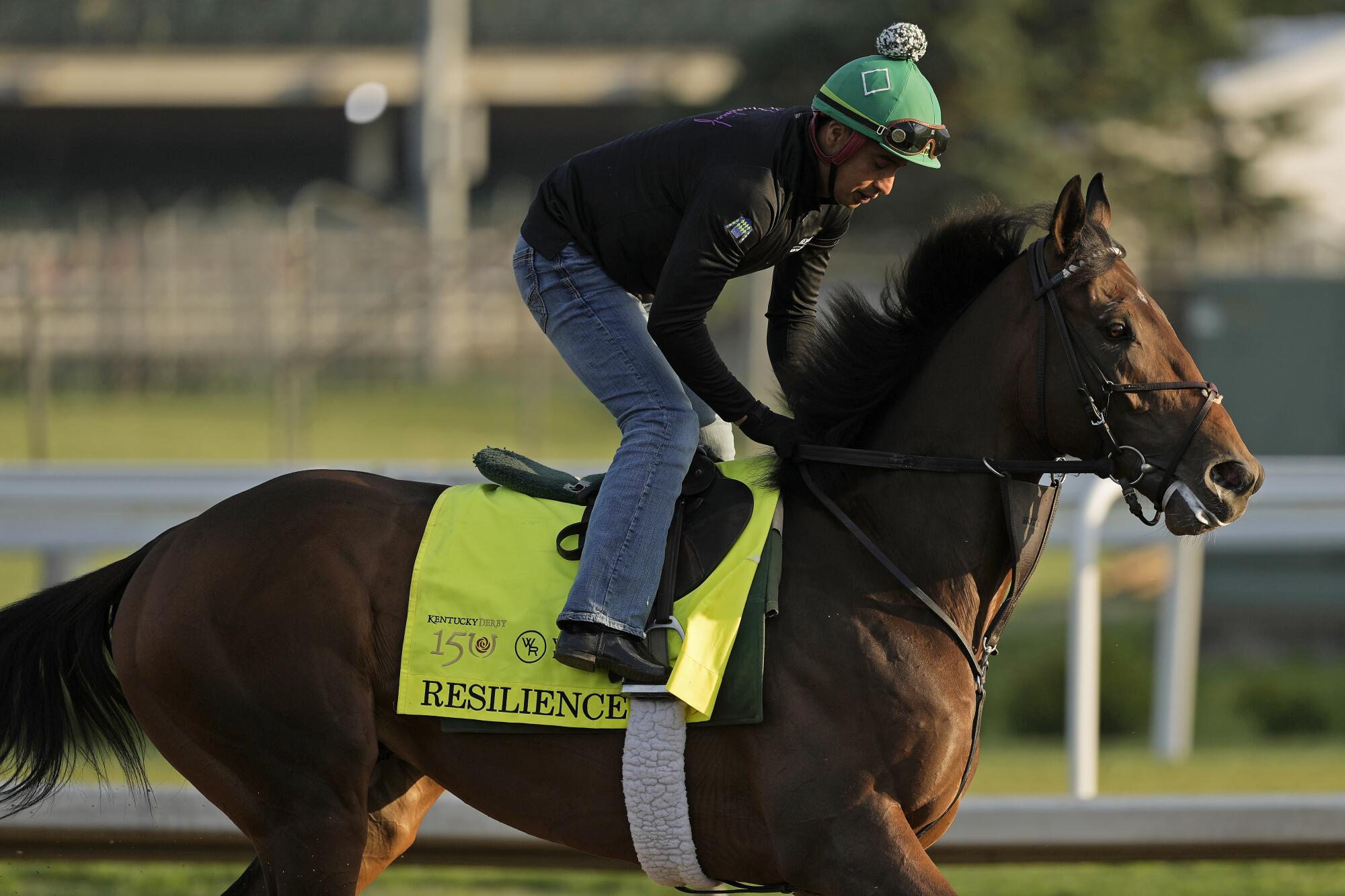 A jockey rides Kentucky Derby hopeful Resilience during a workout at Churchill Downs.