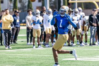 J. Michael Sturdivant raises his hands and watches the ball thrown toward him during a 2023 UCLA spring football practice.