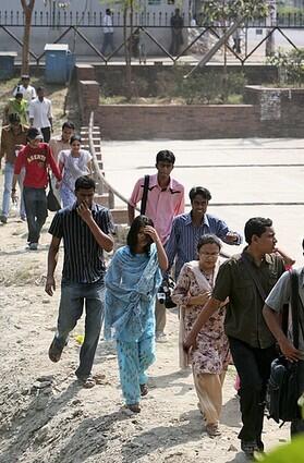 Students of a local education center move to safer places outside the headquarters of Bangladesh Rifles in Dhaka.