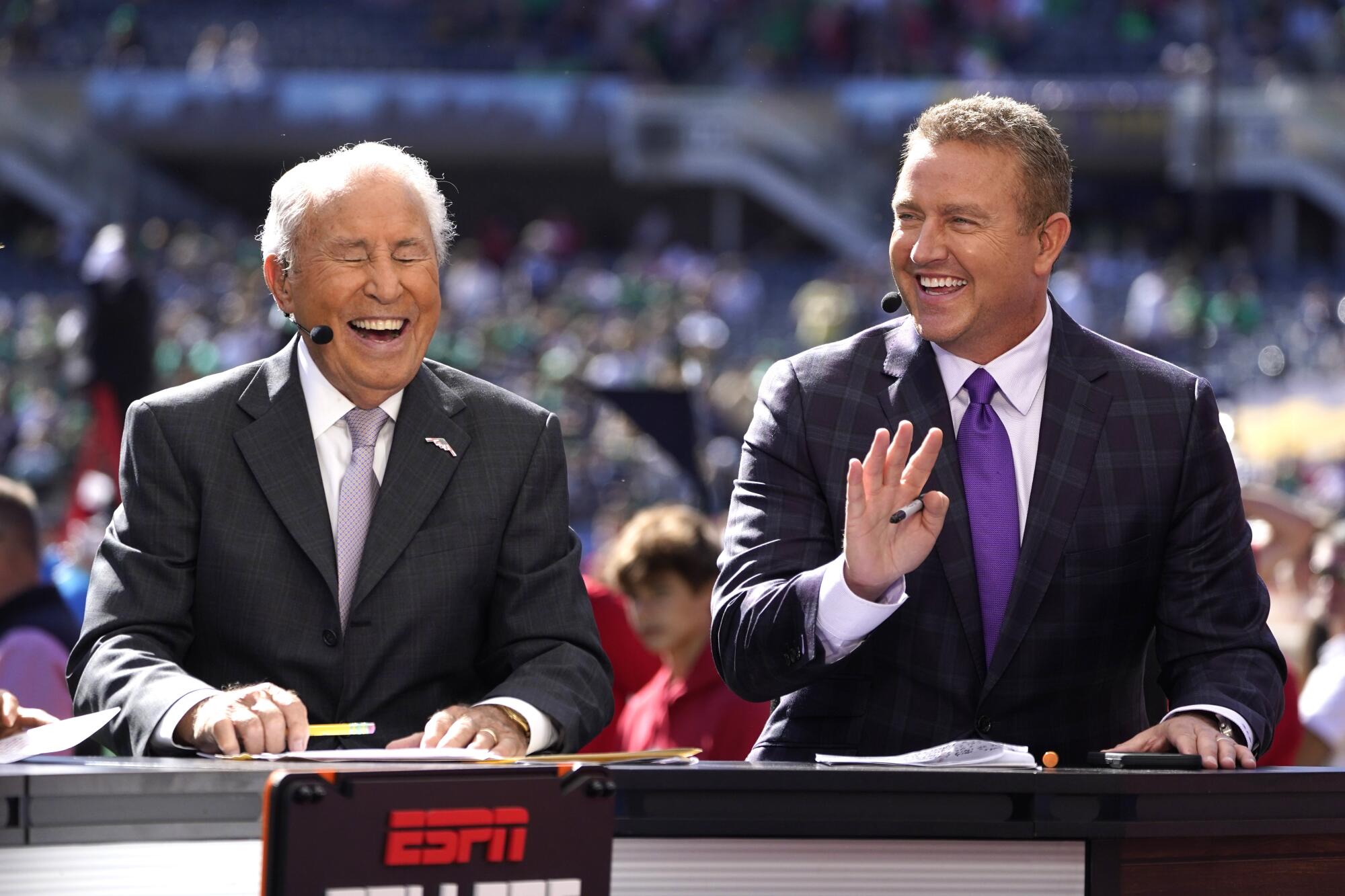 Kirk Herbstreit shares a laugh with Lee Corso on the set of ESPN's College Game Day at Soldier Field 