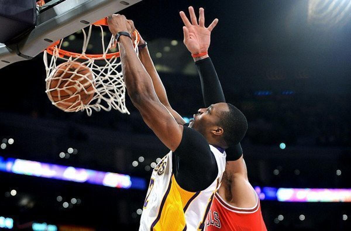 Lakers center Dwight Howard throws down a dunk against the Bulls in the fourth quarter at Staples Center on Sunday afternoon, when he finished with 16 points and 21 rebounds.