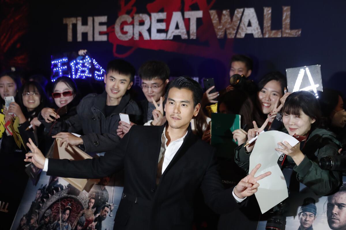Chinese actor Eddie Peng poses in front of Chinese fans as he arrives for a red-carpet event for the movie "The Great Wall" at a hotel in Beijing on Dec. 6. The new China-Hollywood co-production topped the Chinese box office for the second week.