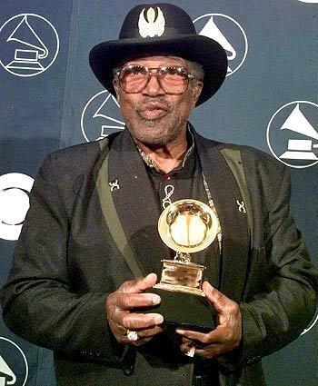 Diddley holds his Grammy for lifetime achievement in 1998. His songs have been covered by the Rolling Stones, Eric Clapton, the Grateful Dead and the Doors, to name just a few.