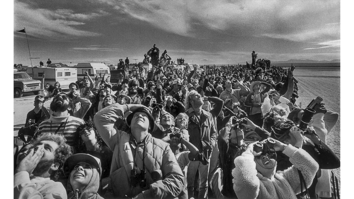 Spectators excitedly fix their eyes on the space shuttle Columbia as it circles to land at Edwards Air Force Base.