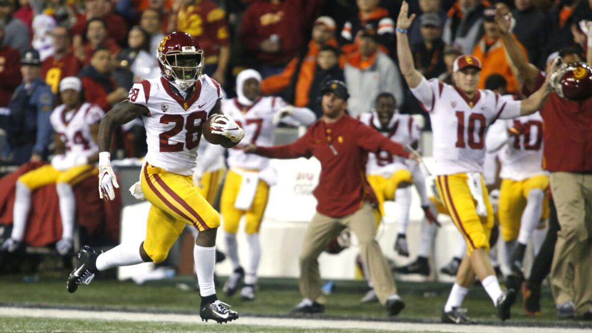 USC's Aca'Cedric Ware races past his bench on a 57-yard touchdown run in the first half against Oregon State on Saturday.