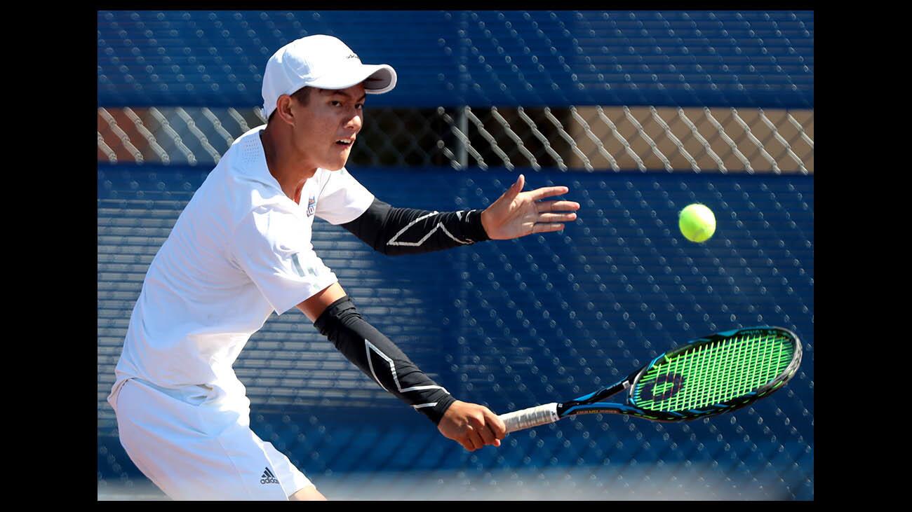 Fountain Valley High School boys tennis player Justin Nguyen returns the ball in match vs. Junipero Serra High in CIF SS Div. 2 semifinal match, at home in Fountain Valley on Wednesday, May 16, 2018.