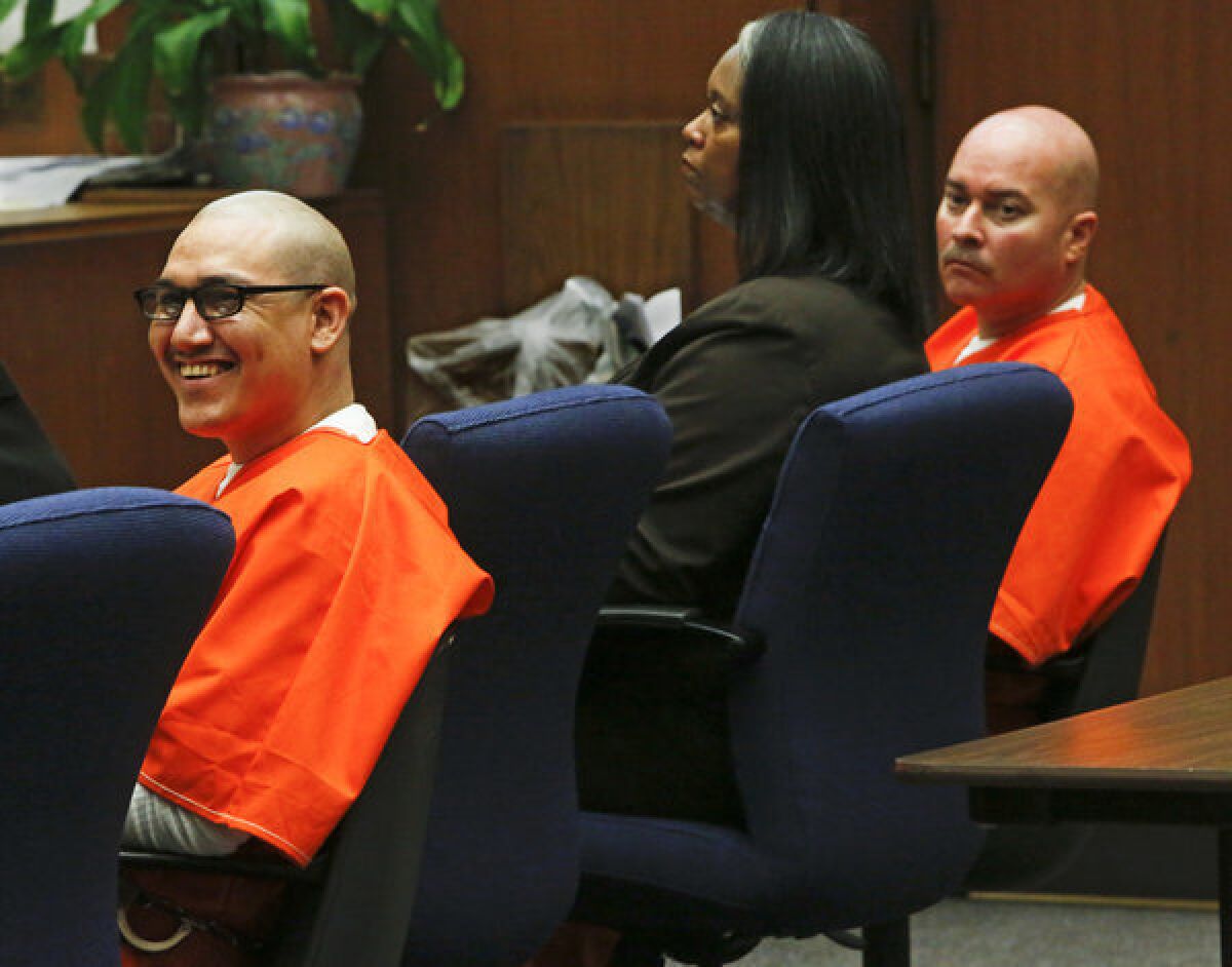 Rudy Ruiz, left, smiles while a relative of one of his victims makes a statement before he and his fellow defendant, John Perez, right, were sentenced to death for killing three people and wounding seven others in a Pico Rivera pizza parlor in 2009. At center is defense lawyer Cynthia Legardye.